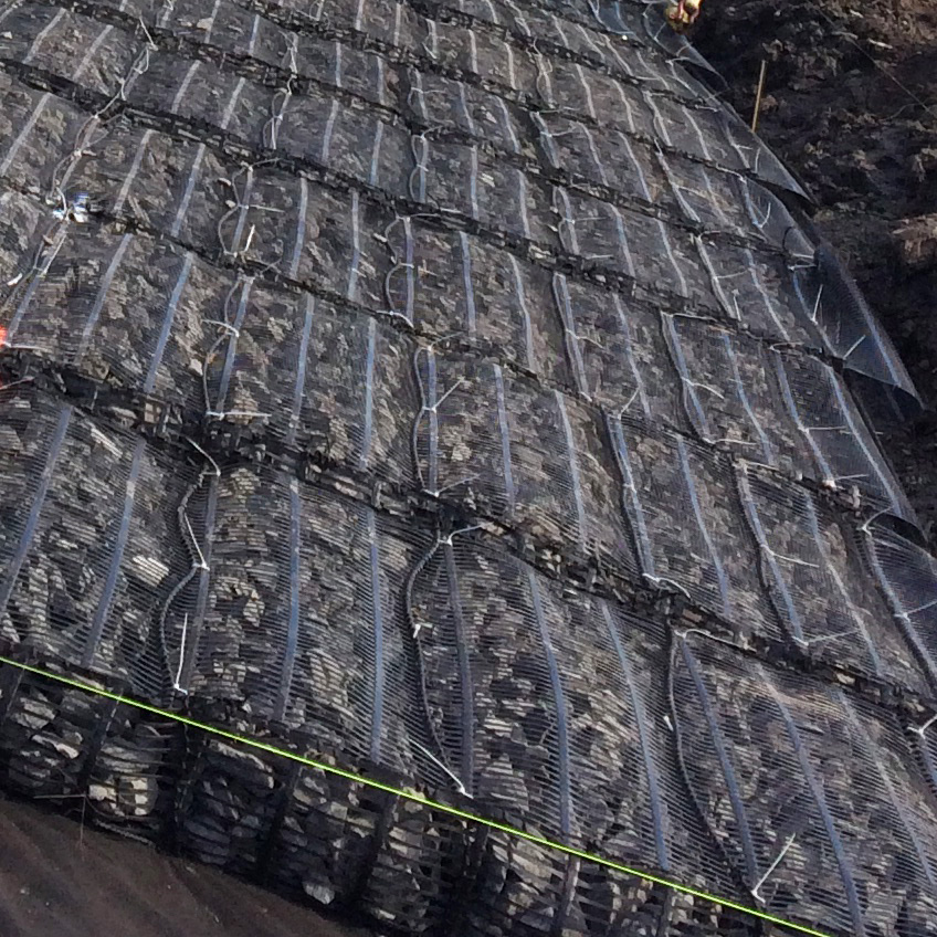 Triton-marine-mattress-installation-in-foreground-along-shoreline