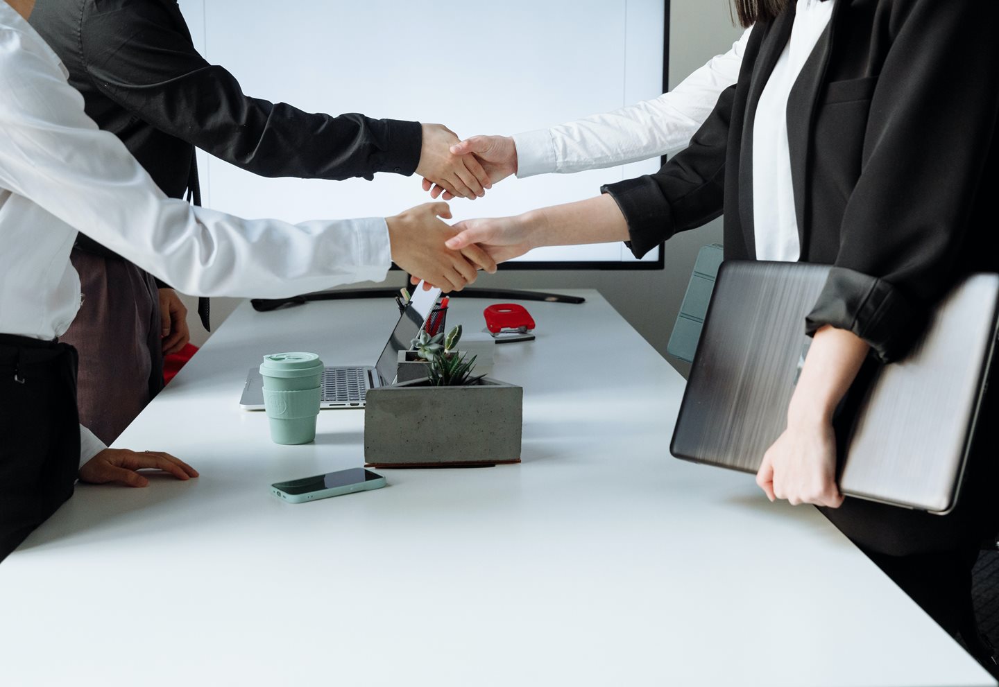 double-handshake-over-table-718x494